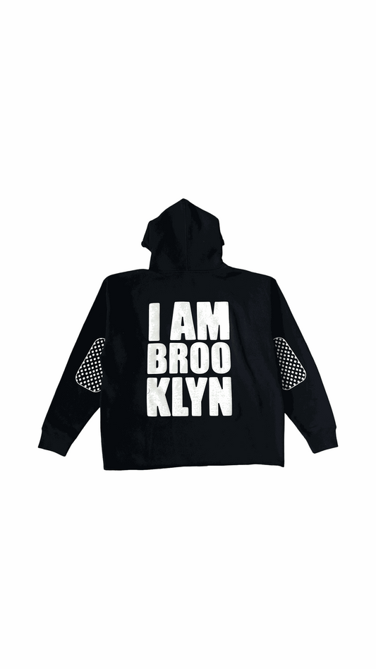 Black I Am Brooklyn Hoodie with bold white text and patterned elbow patches